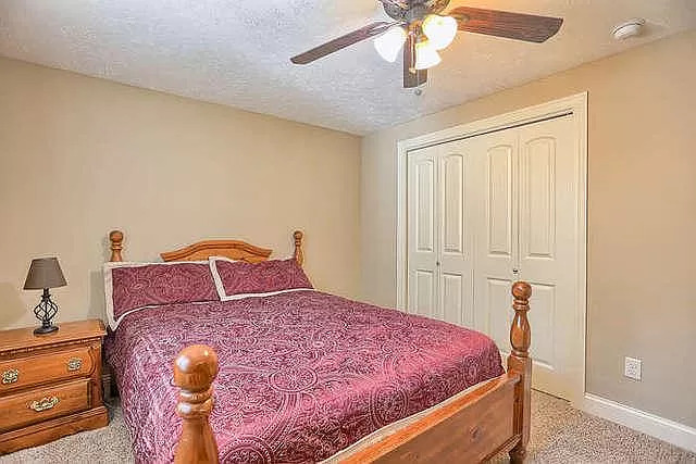 5102 Jacks Boulevard Champaign, IL 61822 - Photo 23 of 36 a bedroom with a bed and a chandelier