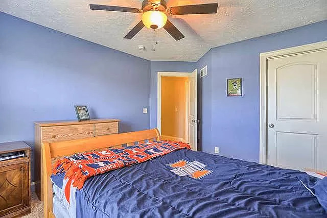 5102 Jacks Boulevard Champaign, IL 61822 - Photo 24 of 36 a bedroom with a bed and a chandelier