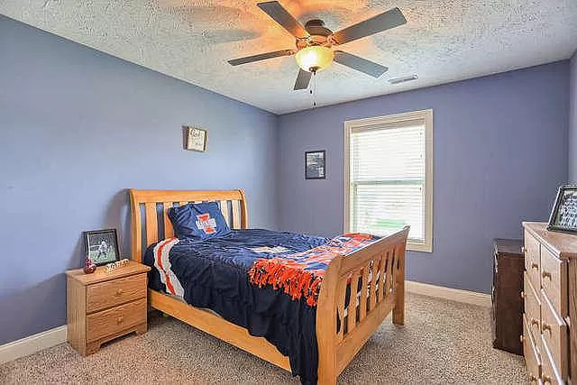 5102 Jacks Boulevard Champaign, IL 61822 - Photo 25 of 36 a bedroom with a bed and a chandelier
