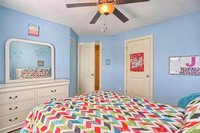 5102 Jacks Boulevard Champaign, IL 61822 - Photo 26 of 36 a bedroom with a bed and a chandelier