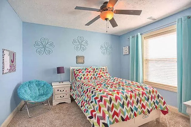 5102 Jacks Boulevard Champaign, IL 61822 - Photo 27 of 36 a bed sitting in a bedroom next to a window