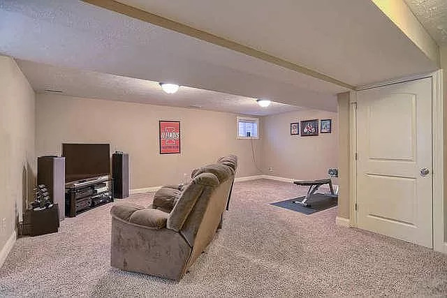 5102 Jacks Boulevard Champaign, IL 61822 - Photo 30 of 36 a living room with furniture a flat screen tv and a window