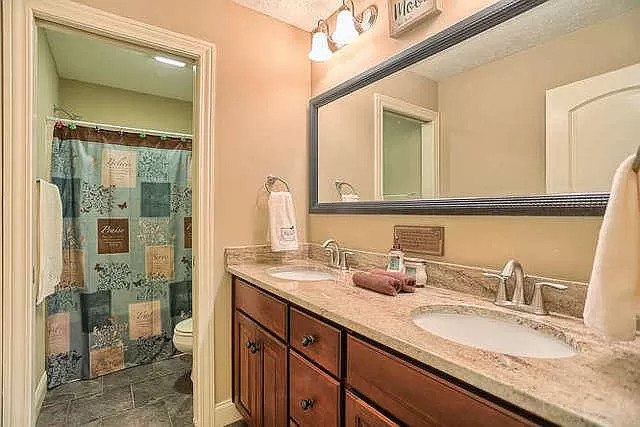 5102 Jacks Boulevard Champaign, IL 61822 - Photo 33 of 36 a bathroom with a granite countertop sink a mirror and a shower
