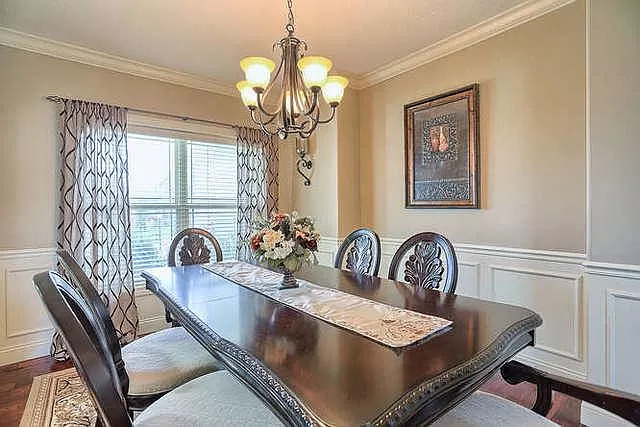 5102 Jacks Boulevard Champaign, IL 61822 - Photo 5 of 36 a view of a dining room with furniture a chandelier and wooden floor