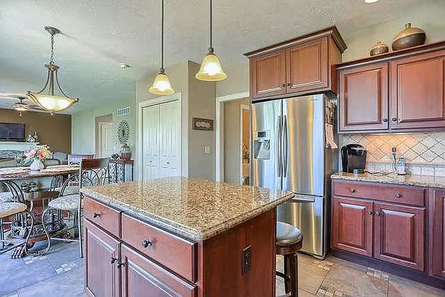 5102 Jacks Boulevard Champaign, IL 61822 - Photo 8 of 36 a kitchen that has a kitchen island a stove a table and chairs in it