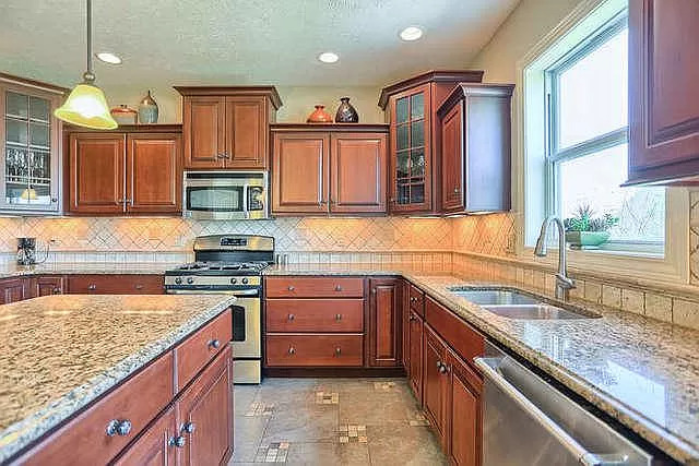5102 Jacks Boulevard Champaign, IL 61822 - Photo 9 of 36 a kitchen with stainless steel appliances granite countertop a sink stove and cabinets