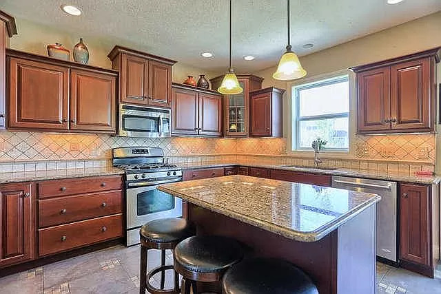 5102 Jacks Boulevard Champaign, IL 61822 - Photo 10 of 36 a kitchen with stainless steel appliances granite countertop a sink a stove and a microwave