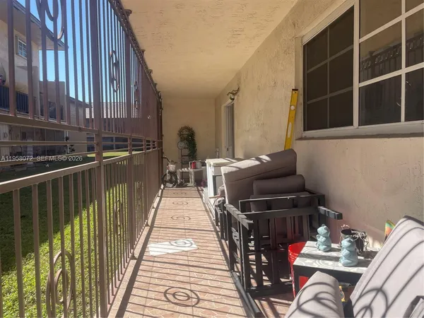 a balcony with furniture and a potted plant