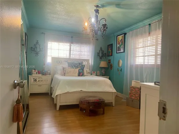 a bed sitting in a bedroom next to a window