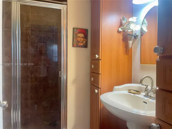 a bathroom with a sink mirror and vanity