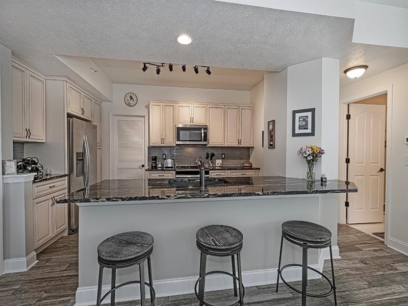 232 Adams Pointe Boulevard, Unit 6 Mars, PA 16046 - Photo 11 of 27 a kitchen with stainless steel appliances granite countertop a sink a stove a refrigerator cabinets and chairs
