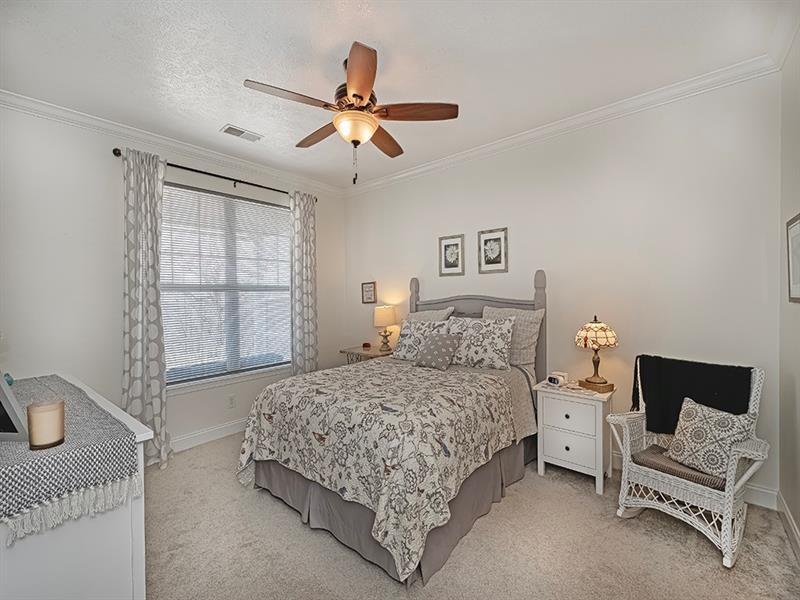 232 Adams Pointe Boulevard, Unit 6 Mars, PA 16046 - Photo 12 of 27 a bedroom with a bed and a chandelier