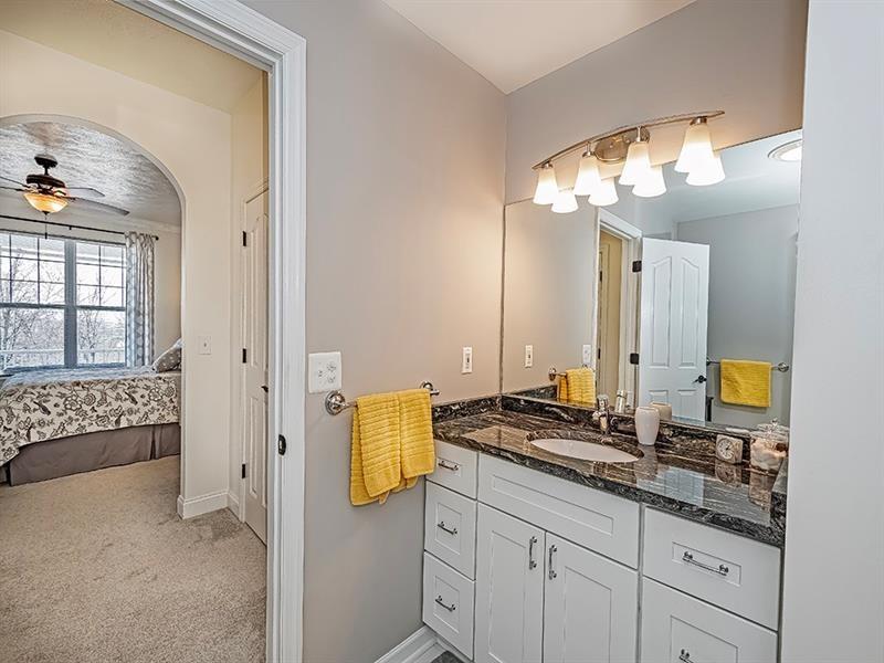232 Adams Pointe Boulevard, Unit 6 Mars, PA 16046 - Photo 15 of 27 a bathroom with a granite countertop sink and a mirror