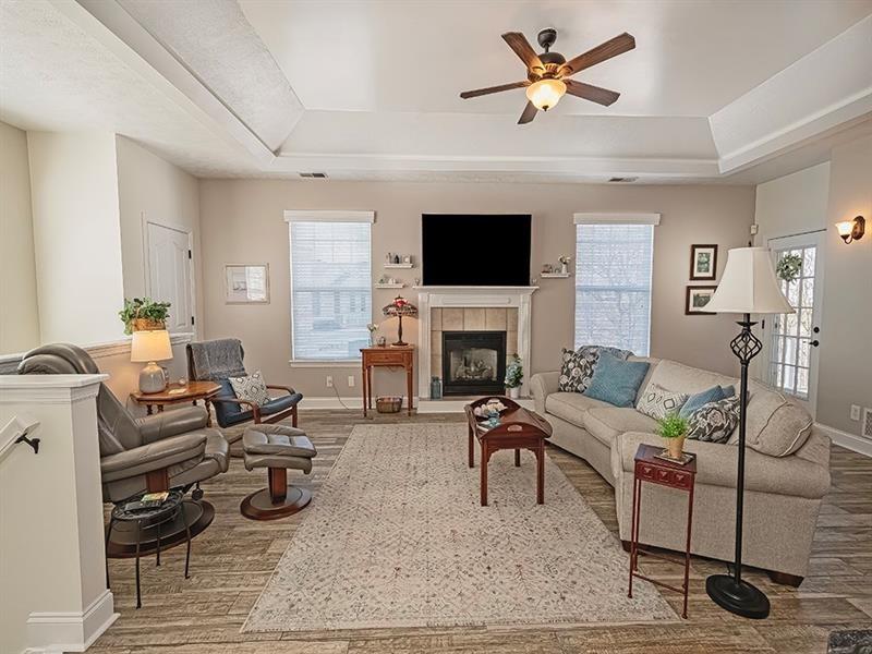 232 Adams Pointe Boulevard, Unit 6 Mars, PA 16046 - Photo 2 of 27 a living room with furniture a fireplace and a flat screen tv