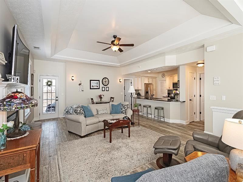 232 Adams Pointe Boulevard, Unit 6 Mars, PA 16046 - Photo 4 of 27 a living room with furniture and a flat screen tv