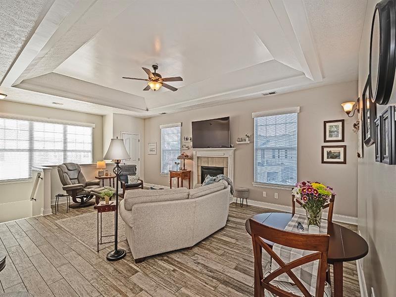 232 Adams Pointe Boulevard, Unit 6 Mars, PA 16046 - Photo 5 of 27 a living room with furniture and a flat screen tv