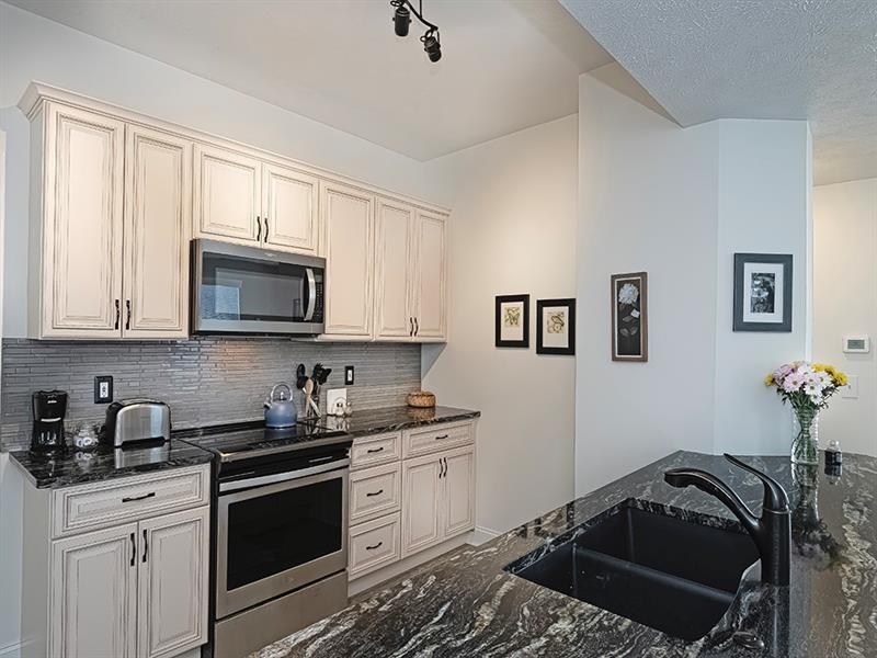 232 Adams Pointe Boulevard, Unit 6 Mars, PA 16046 - Photo 7 of 27 a kitchen with a sink stove and microwave