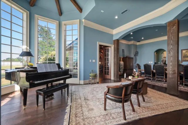 a living room with furniture and a piano