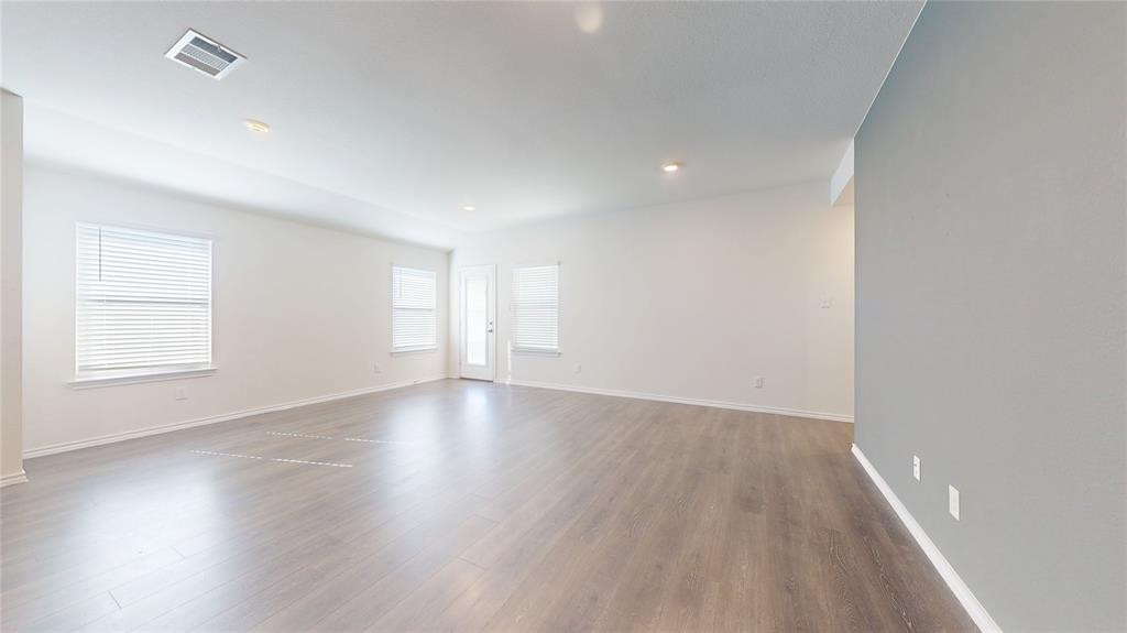 1616 Flt Rdg Court Royse City, TX 75189 - Photo 11 of 26 an empty room with wooden floor and windows