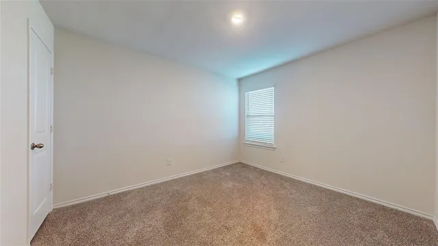 a view of an empty room and a window