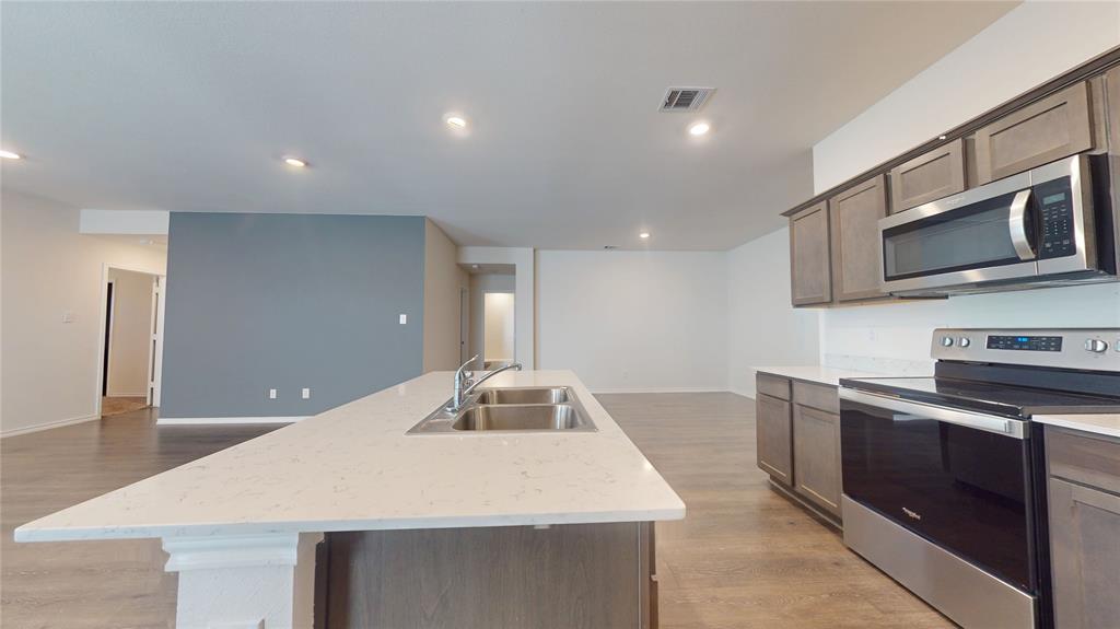 1616 Flt Rdg Court Royse City, TX 75189 - Photo 3 of 26 a kitchen with stainless steel appliances granite countertop a sink and microwave