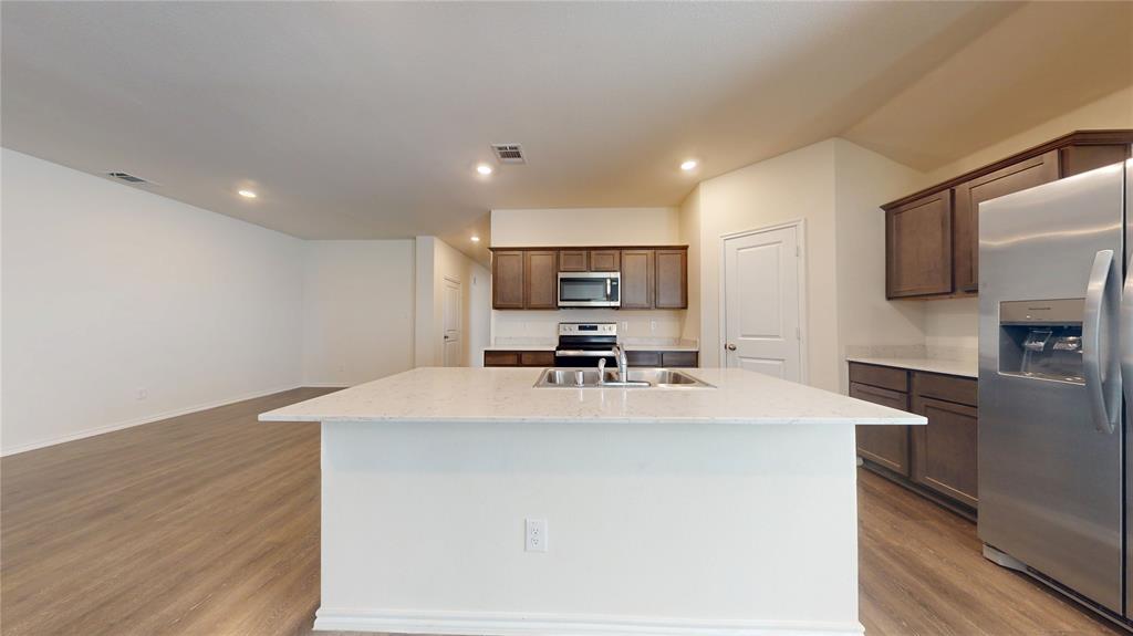 1616 Flt Rdg Court Royse City, TX 75189 - Photo 4 of 26 a kitchen with stainless steel appliances a refrigerator sink and microwave