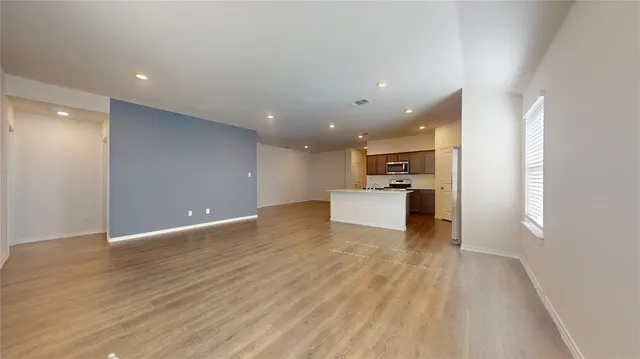 a view of a kitchen with a sink and a refrigerator