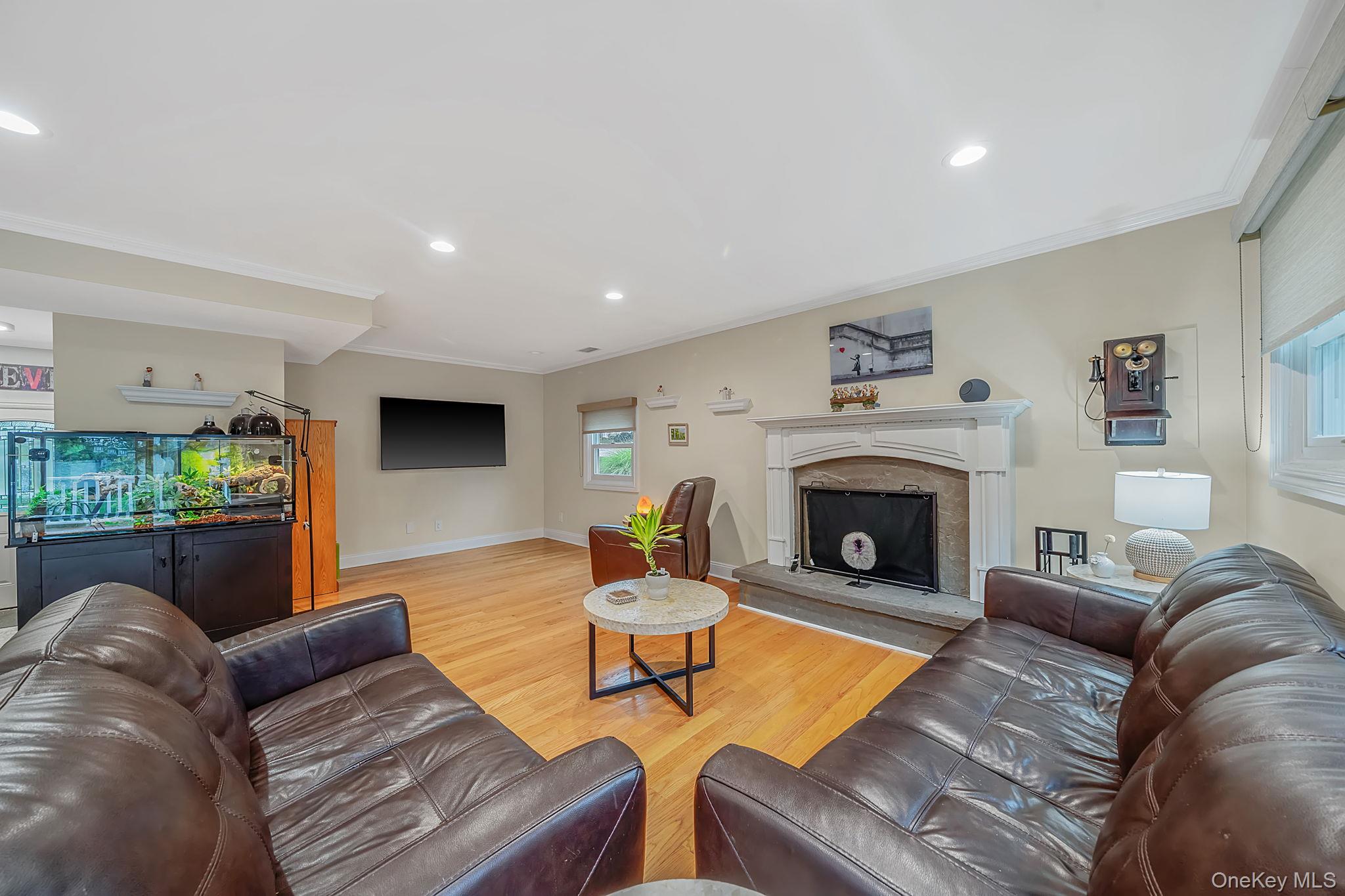 5 Rockhill Road Rocky Point, NY 11778 - Photo 17 of 48 Bright family room featuring hardwood flooring, recessed lighting, and crown molding