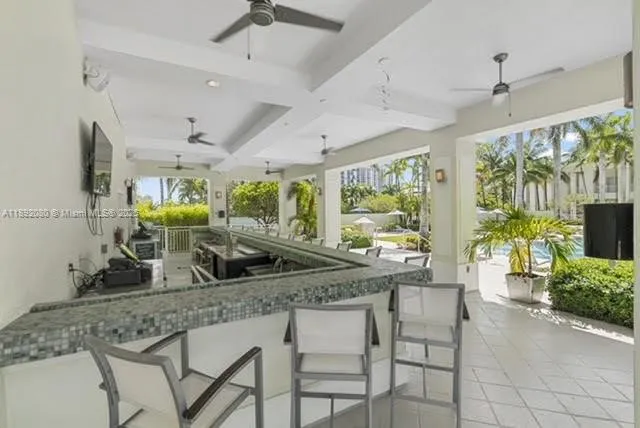 a kitchen with a table chairs sink and wooden floor