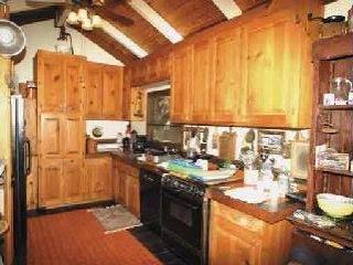12210 Graton Road Sebastopol, CA 95472 - Photo 3 of 11 a kitchen with a sink a stove and a wooden cabinets