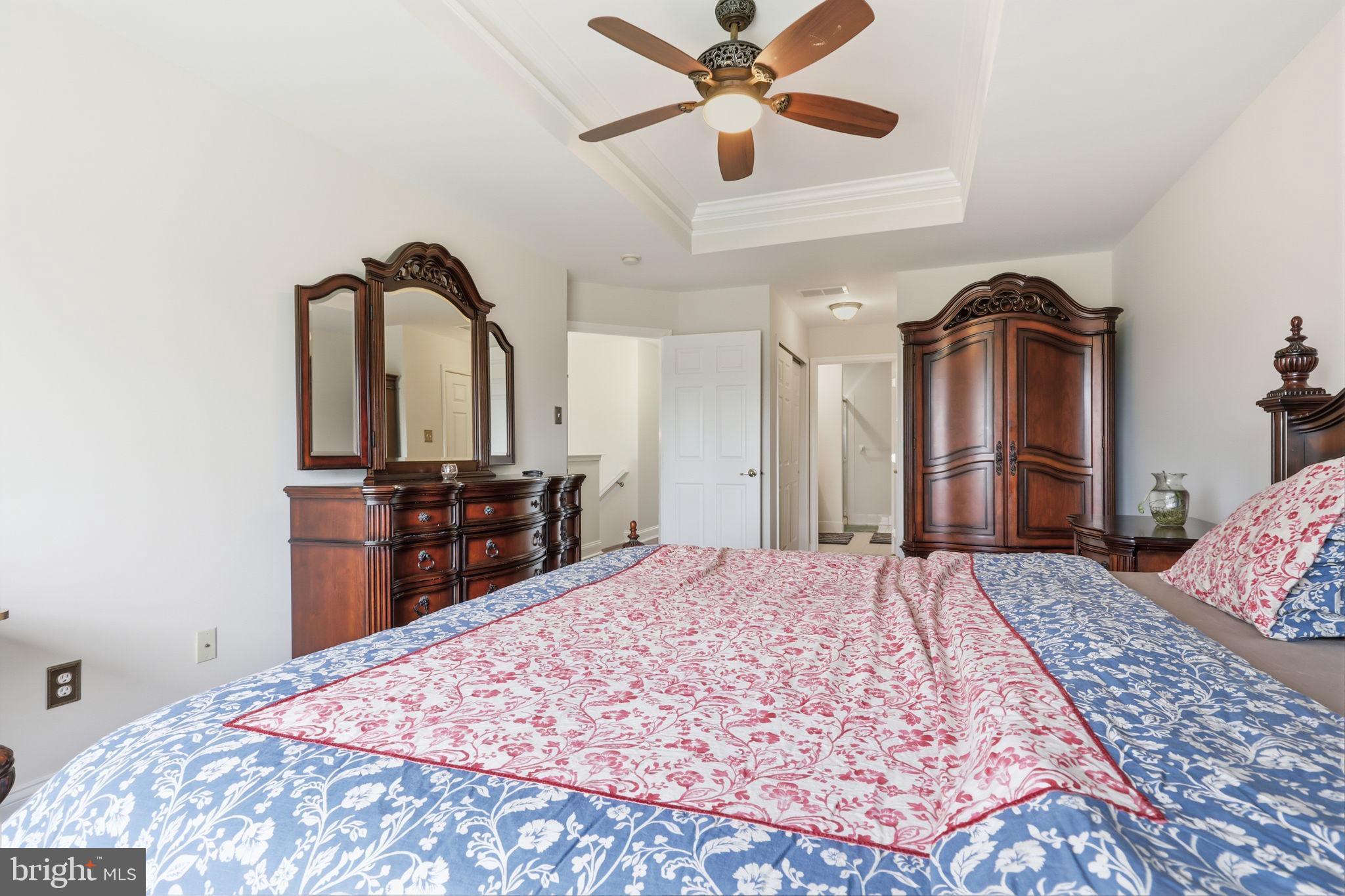7 Wellington Road Newtown, PA 18940 - Photo 18 of 49 a bedroom with a bed and a chandelier