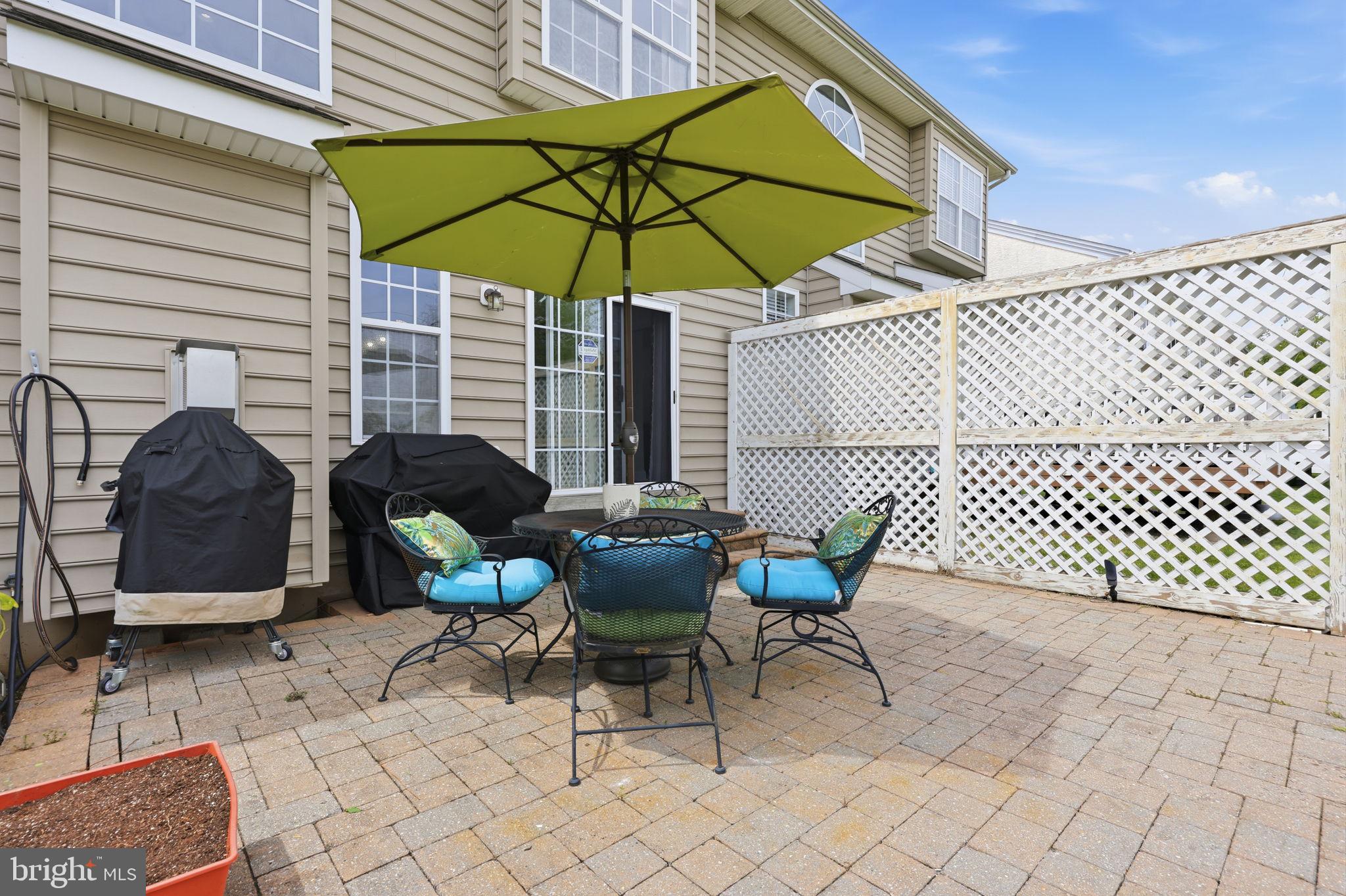 7 Wellington Road Newtown, PA 18940 - Photo 35 of 49 a patio with a patio table and chairs