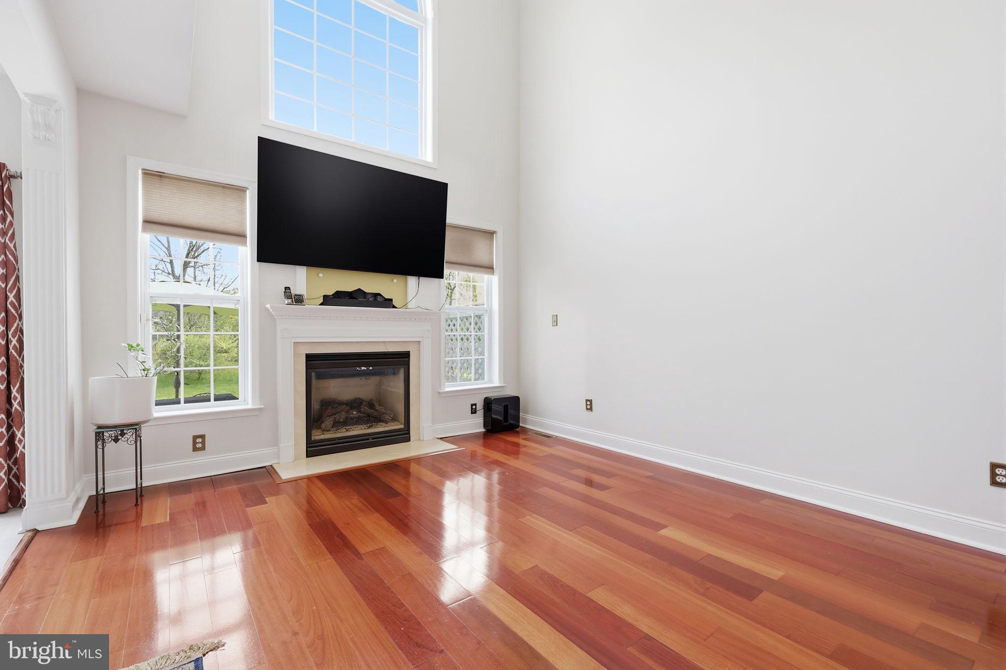 7 Wellington Road Newtown, PA 18940 - Photo 10 of 49 a view of livingroom with fireplace flat screen tv and window