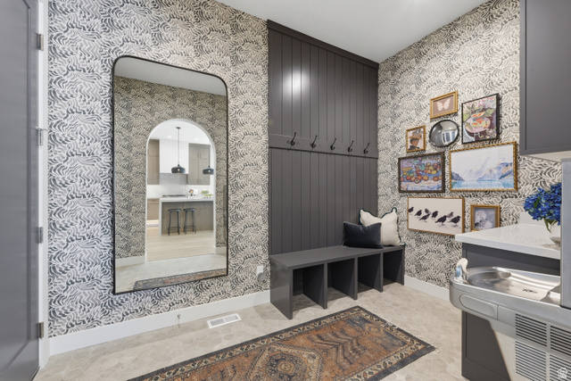 2559 West Aurora Avenue Mapleton, UT 84664 - Photo 5 of 60 Entryway featuring patterned wallpaper, a built-in bench with storage cubbies, and a wall-mounted coat rack