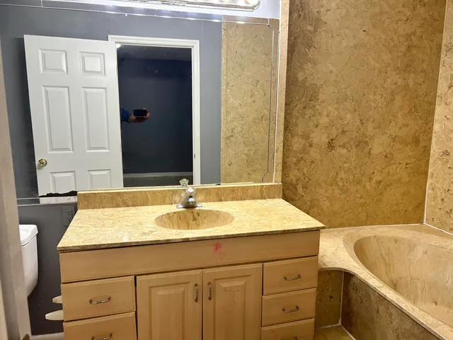 a bathroom with a bathtub and shower