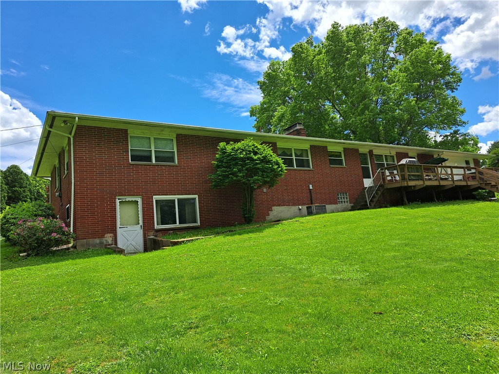 3905 Mark Road Cambridge, OH 43725 - Photo 5 of 50 Rear view of house with a wooden deck and a lawn