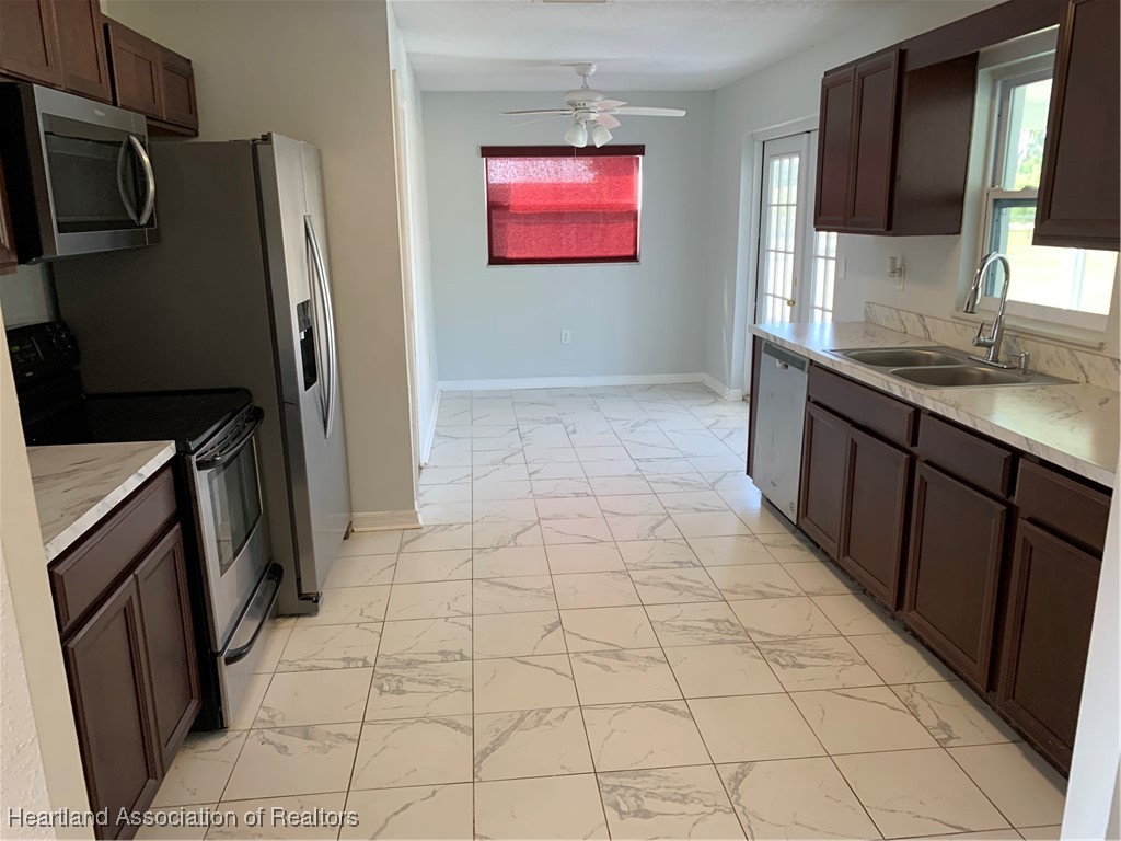 6101 Edgewater Terrace Sebring, FL 33876 - Photo 3 of 10 a bathroom with a sink a mirror and a shower