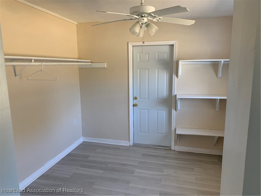 6101 Edgewater Terrace Sebring, FL 33876 - Photo 5 of 10 a view of an empty room with wooden floor