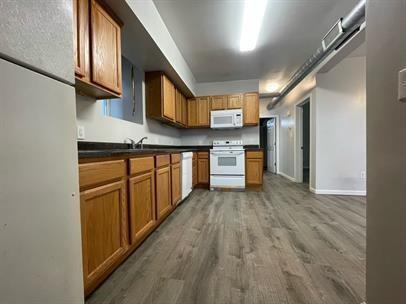 340 North Craig Street Pittsburgh, PA 15213 - Photo 2 of 3 a kitchen with stainless steel appliances granite countertop a refrigerator a stove and a sink with wooden cabinets