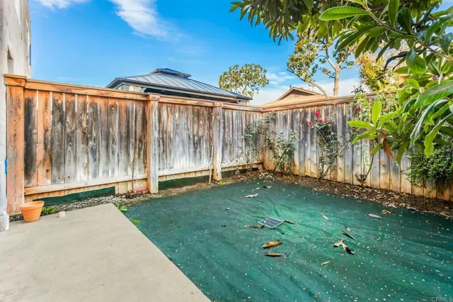 a backyard of a house with a garden and outdoor seating