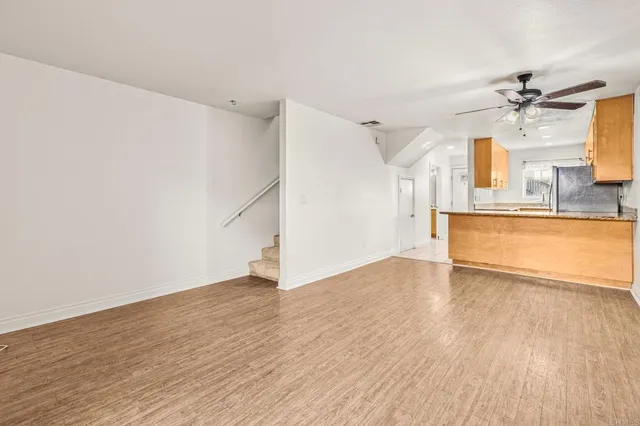 a view of a kitchen with wooden floor and a sink