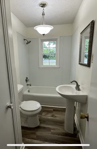 a bathroom with a sink toilet and a mirror