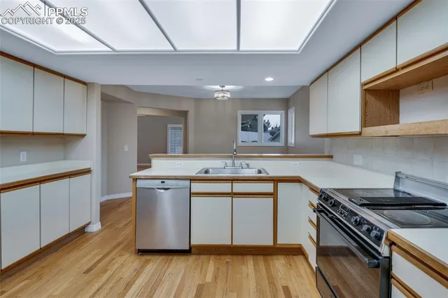 a kitchen with a sink stainless steel appliances and cabinets