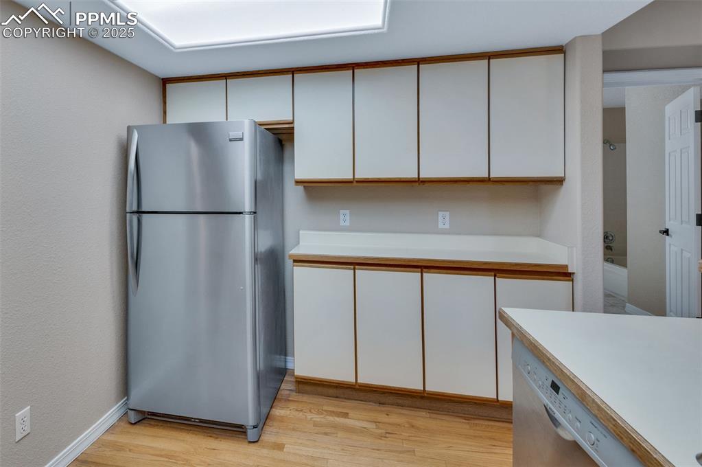 5125 Lewisia Point Colorado Springs, CO 80917 - Photo 14 of 32 a kitchen with a refrigerator and cabinets