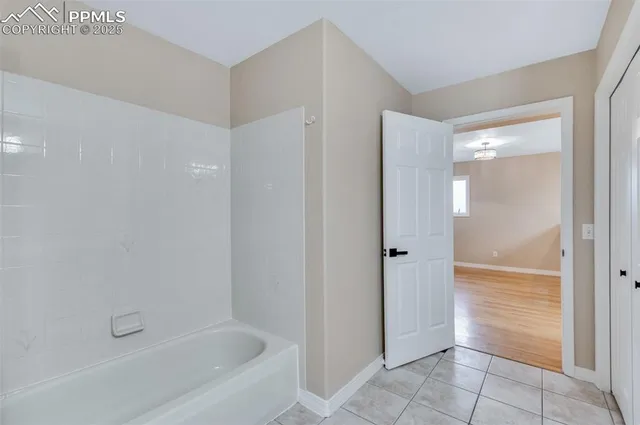 a bathroom with a bathtub and shower