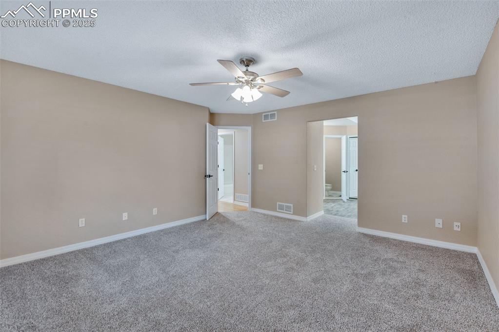 5125 Lewisia Point Colorado Springs, CO 80917 - Photo 19 of 32 a view of an empty room with a ceiling fan