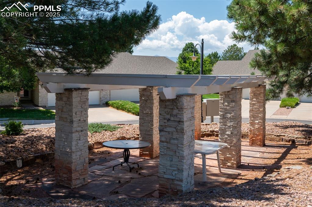 5125 Lewisia Point Colorado Springs, CO 80917 - Photo 32 of 32 a front view of a house with a yard fountain and large tree