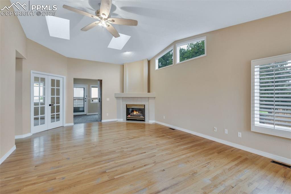5125 Lewisia Point Colorado Springs, CO 80917 - Photo 5 of 32 a view of an empty room with wooden floor and a window