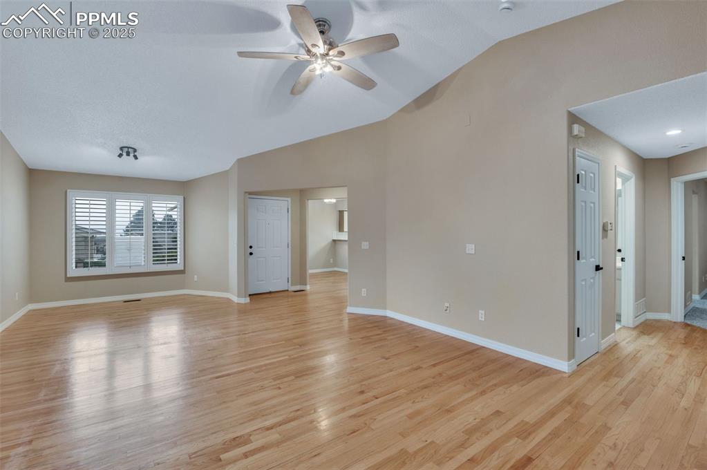 5125 Lewisia Point Colorado Springs, CO 80917 - Photo 7 of 32 a view of an empty room with a window and wooden floor