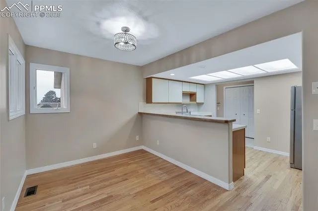 a view with cabinets and wooden floor